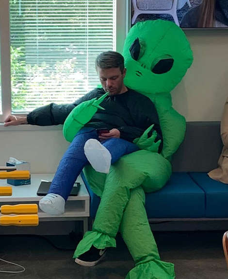 expel employee in alien halloween costume