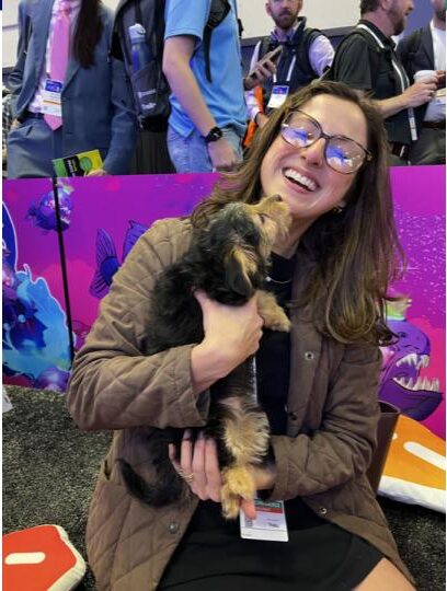 An Expel employee plays with a puppy at RSAC 2025. 