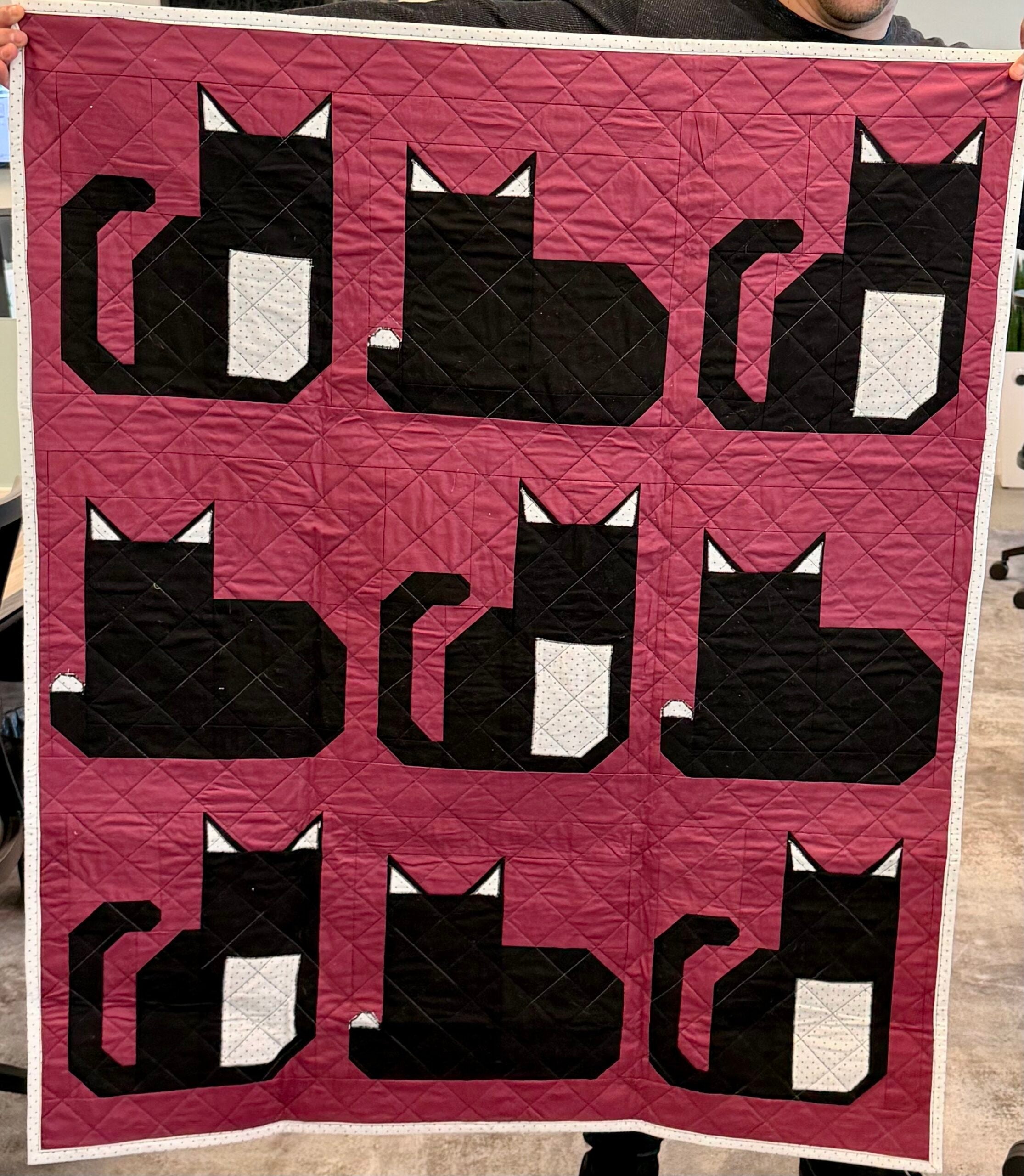 A quilt with cats